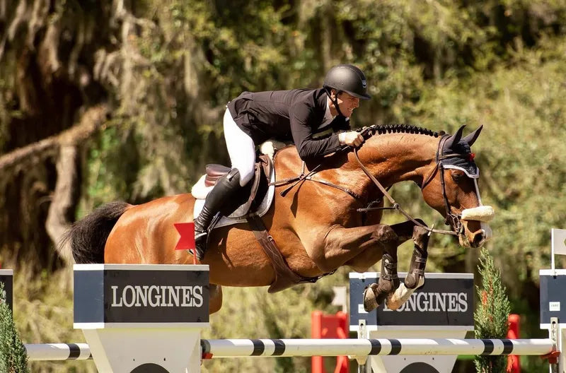 Show jumper clearing a Longines oxer