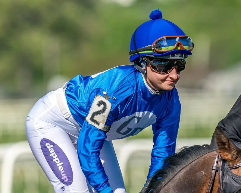 Jockey Martina Rojas racing past Dapple Up branded rail